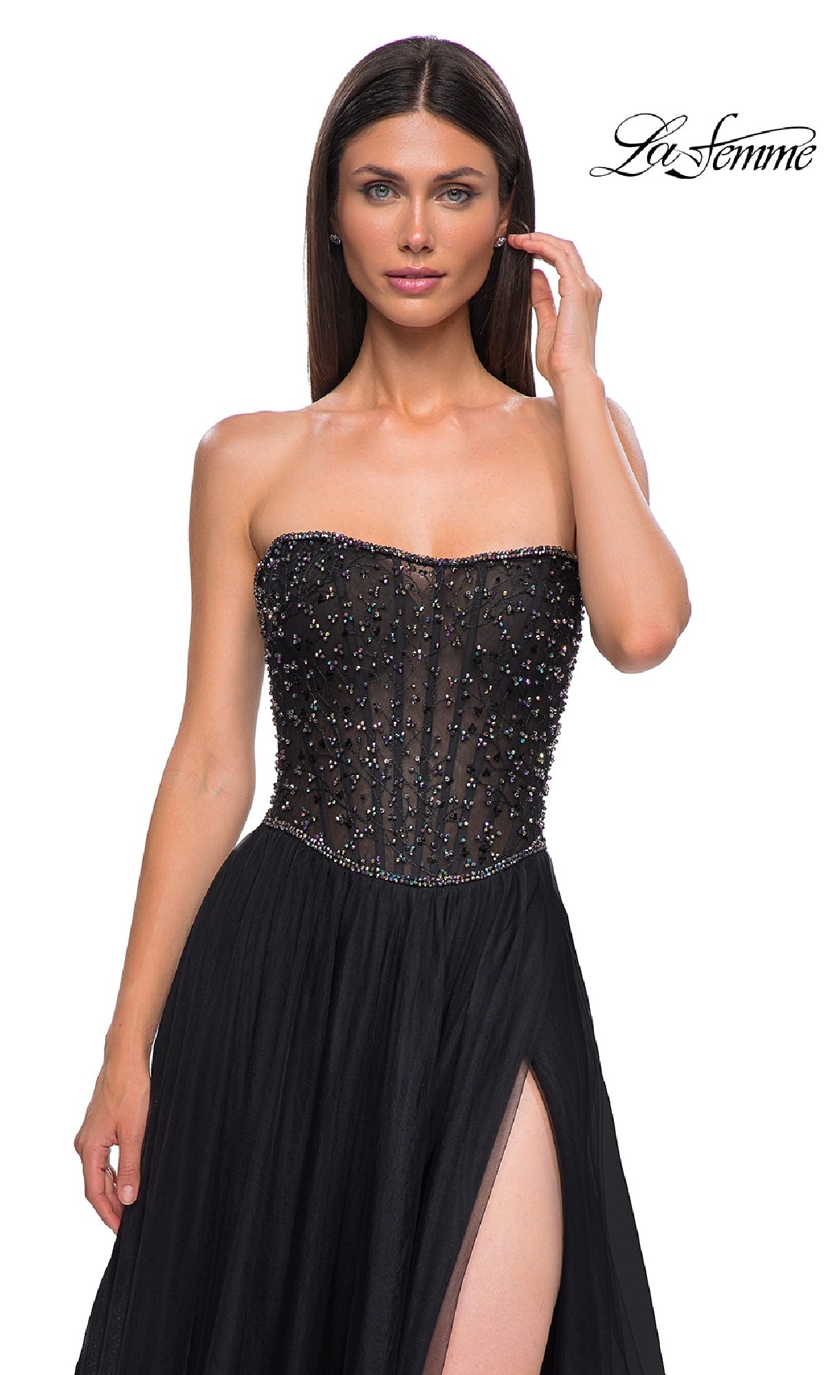 A woman poses against a white background in the Strapless Long Black Prom Ball Gown: La Femme 32856, featuring a beaded bodice and high-slit skirt. The